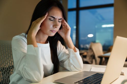 stressed woman sitting at her desk