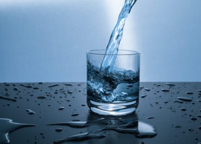 water being poured into clear drinking glass