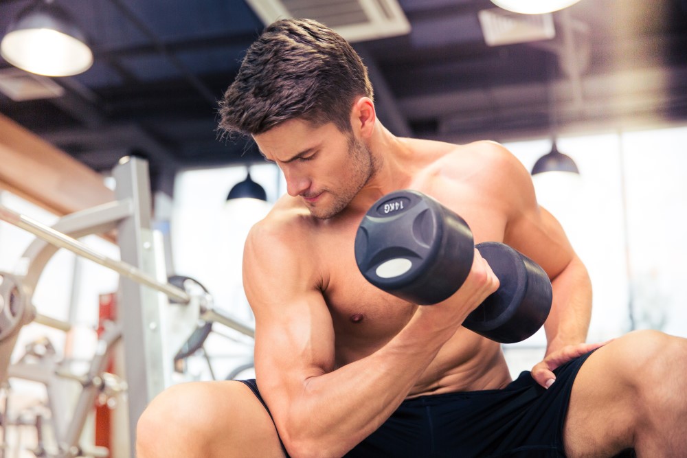 man-workout-with-dumbbell-at-gym