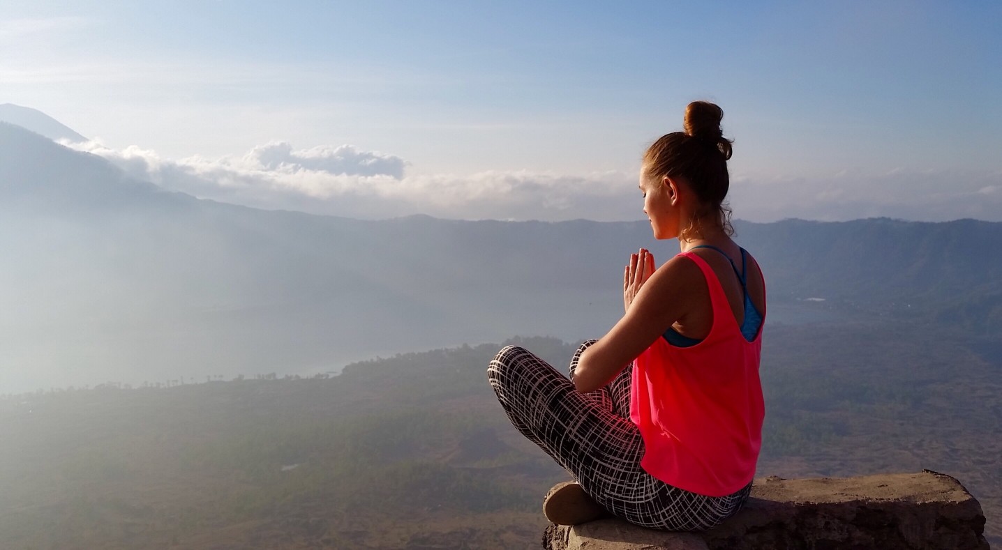 Meditation at the sunrise at the top of mount batur in bali indonesia